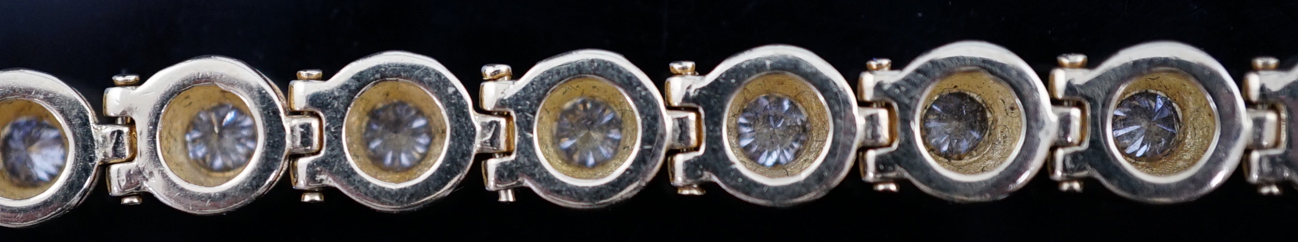 A modern 18ct gold and twenty six round brilliant cut diamond set line bracelet